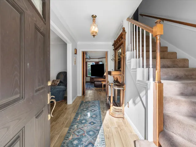 a living room with furniture a fireplace and gym equipment