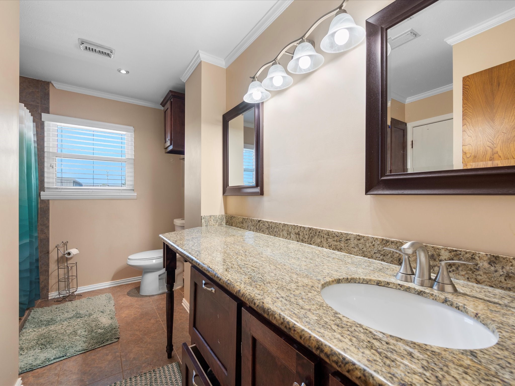 13718 Balmore Circle Houston, TX 77069 - Photo 9 of 35 a bathroom with a granite countertop sink and a mirror