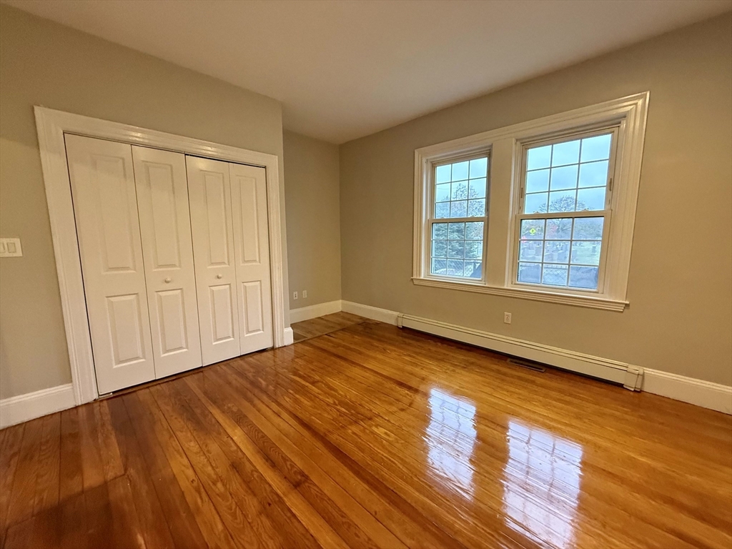89 Grove Street, Unit 89 Belmont, MA 02478 - Photo 11 of 27 a view of an empty room with wooden floor and a window