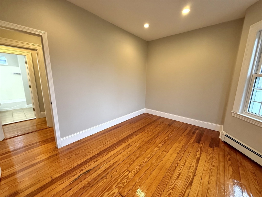 89 Grove Street, Unit 89 Belmont, MA 02478 - Photo 15 of 27 a view of empty room with wooden floor and fan