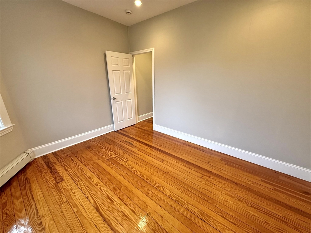 89 Grove Street, Unit 89 Belmont, MA 02478 - Photo 16 of 27 a view of empty room with wooden floor