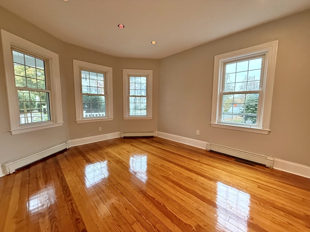 89 Grove Street, Unit 89 Belmont, MA 02478 - Photo 18 of 27 a view of empty room with wooden floor and fan