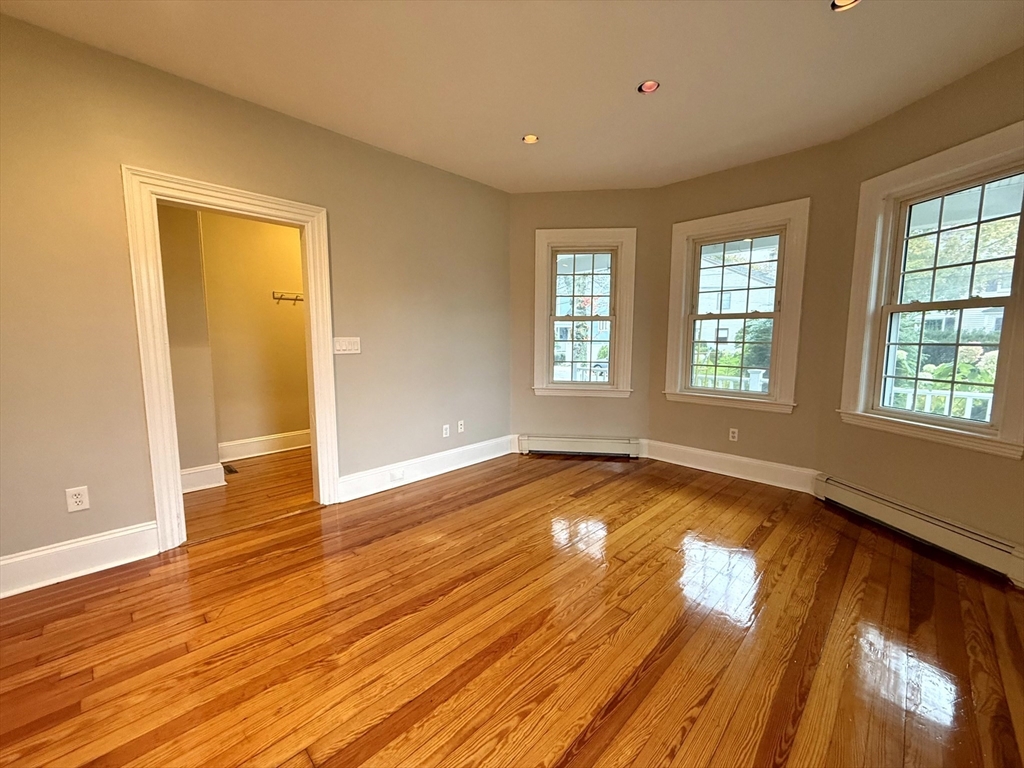 89 Grove Street, Unit 89 Belmont, MA 02478 - Photo 19 of 27 a view of empty room with wooden floor and fan