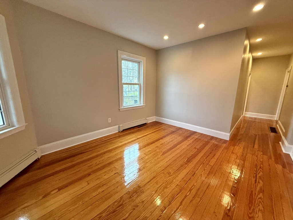 89 Grove Street, Unit 89 Belmont, MA 02478 - Photo 21 of 27 a view of empty room with wooden floor and fan