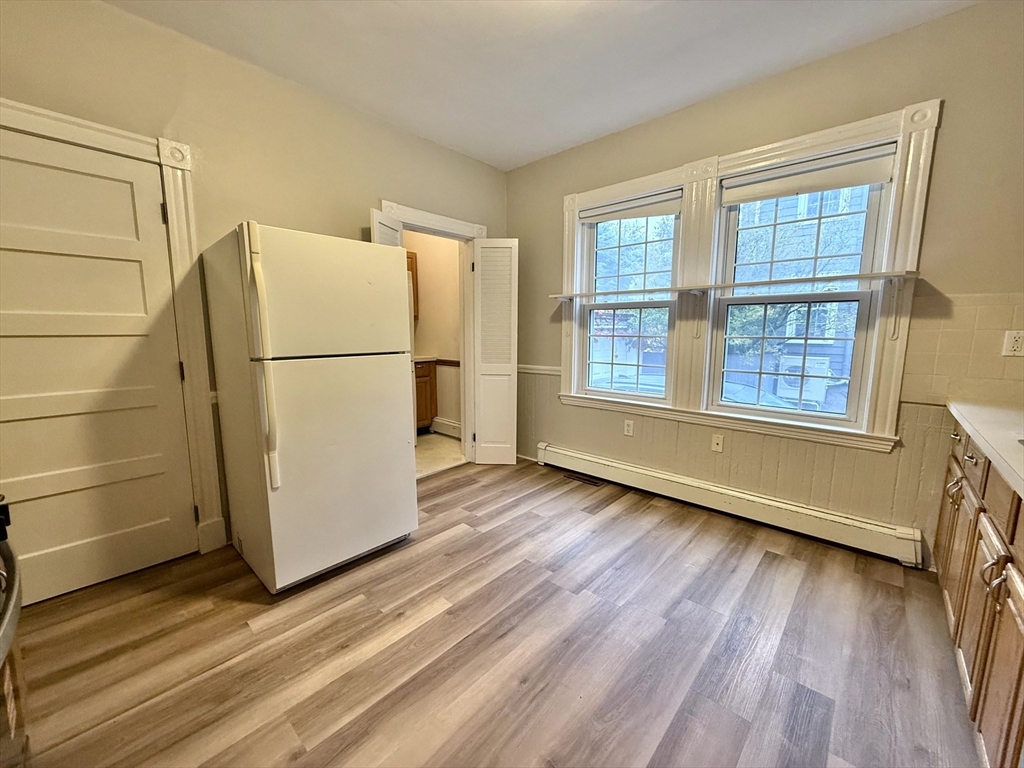 89 Grove Street, Unit 89 Belmont, MA 02478 - Photo 5 of 27 a view of a room with wooden floor and a large window
