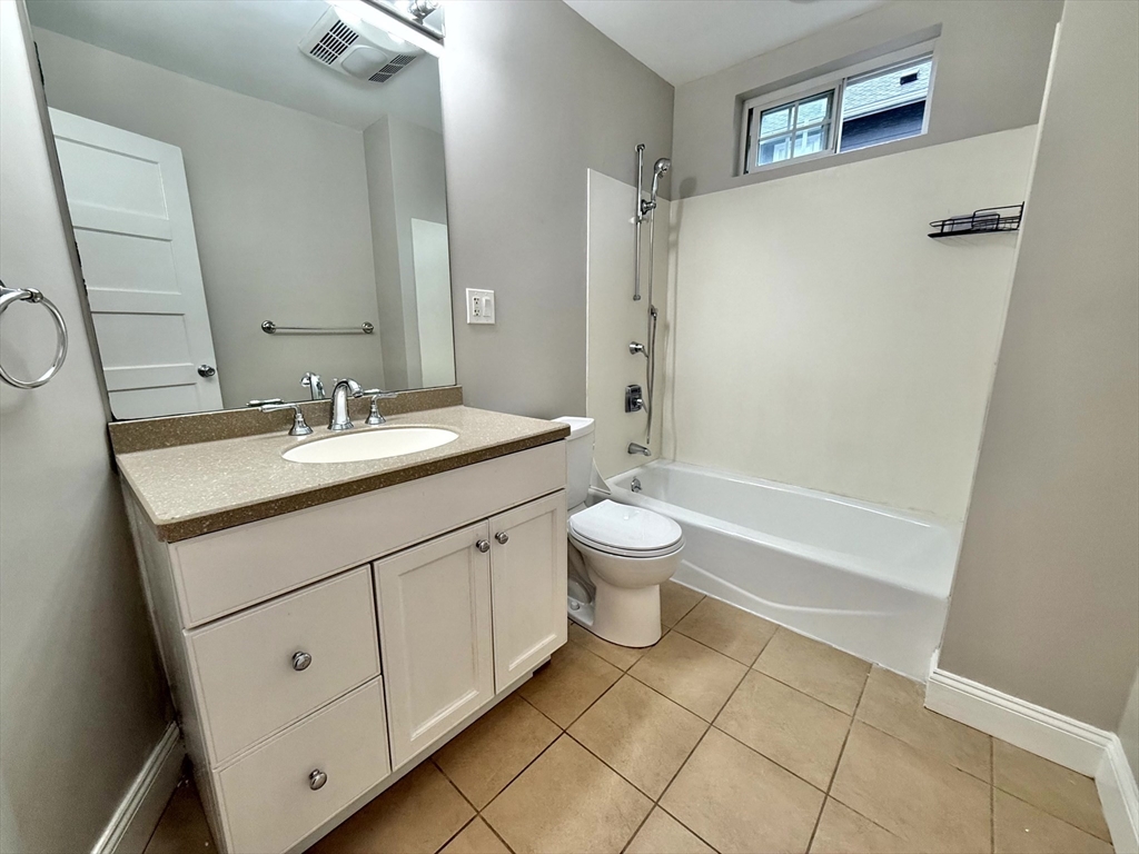 89 Grove Street, Unit 89 Belmont, MA 02478 - Photo 7 of 27 a bathroom with a sink a toilet and shower
