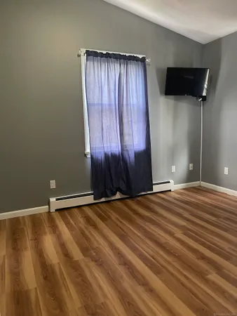 a kitchen with cabinets and wooden floor