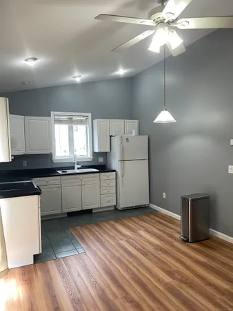 a kitchen with granite countertop a sink and a stove top oven