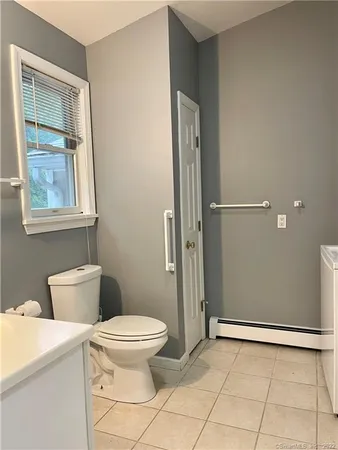 a bathroom with a sink toilet and mirror