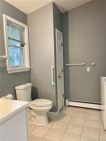 a bathroom with a sink toilet and mirror