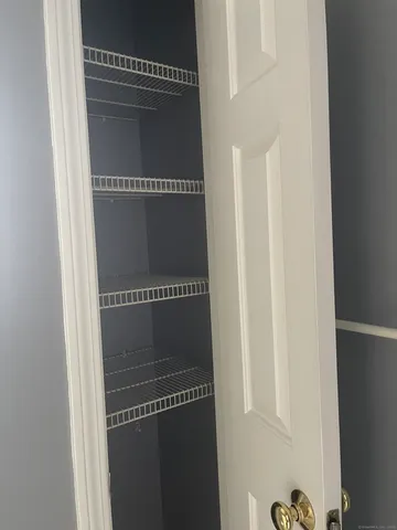 a kitchen with kitchen island granite countertop a stove cabinets and wooden floor