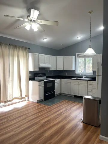 a kitchen with cabinets a counter top space a sink and appliances
