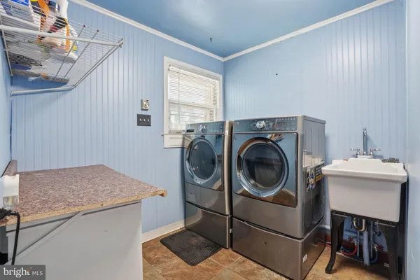a bathroom with a granite countertop sink a toilet and a shower