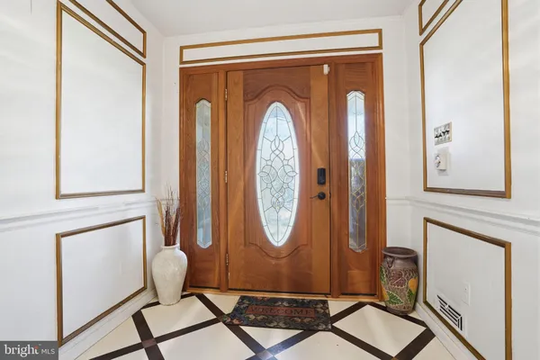 a bathroom with a glass shower door a bathtub a sink and a mirror