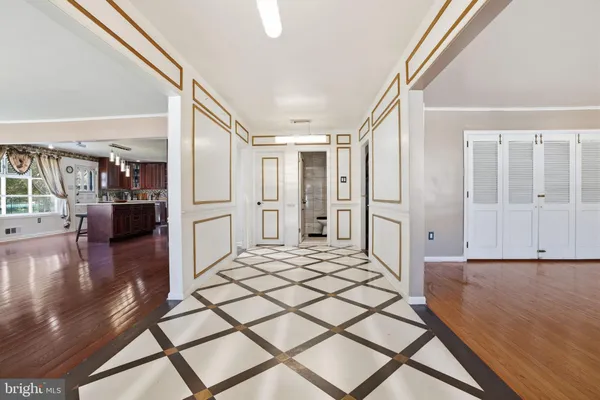 a view of a livingroom with wooden floor and a ceiling fan
