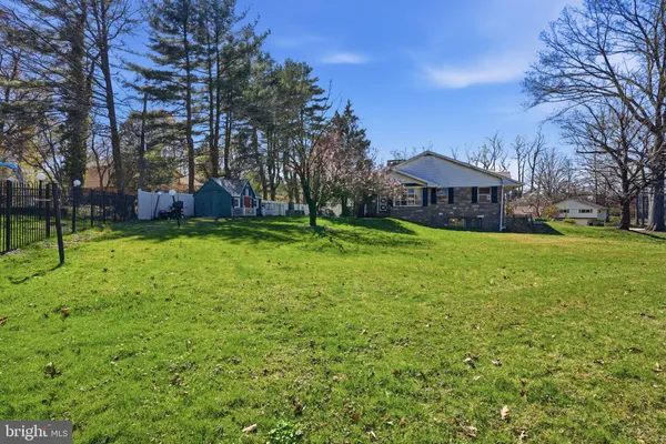 a front view of house with yard outdoor seating and barbeque oven
