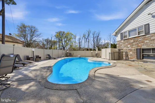a view of a house with a yard and tree s