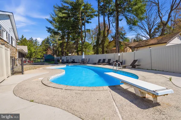 an aerial view of a house with a yard basket ball court and outdoor seating