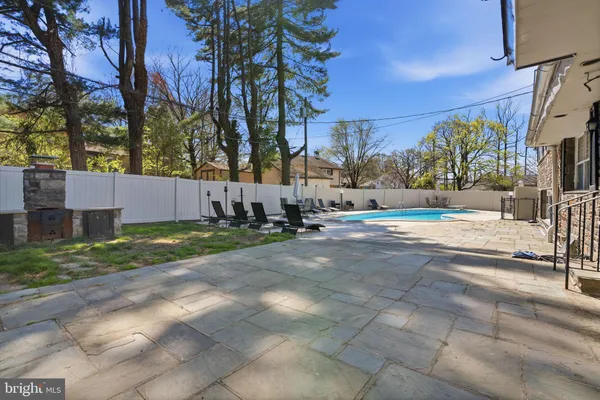 an aerial view of a house with a garden and swimming pool
