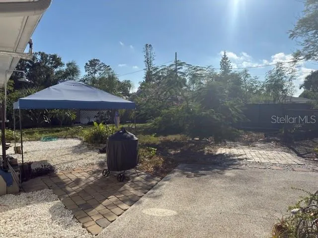 a view of a patio with furniture and a yard