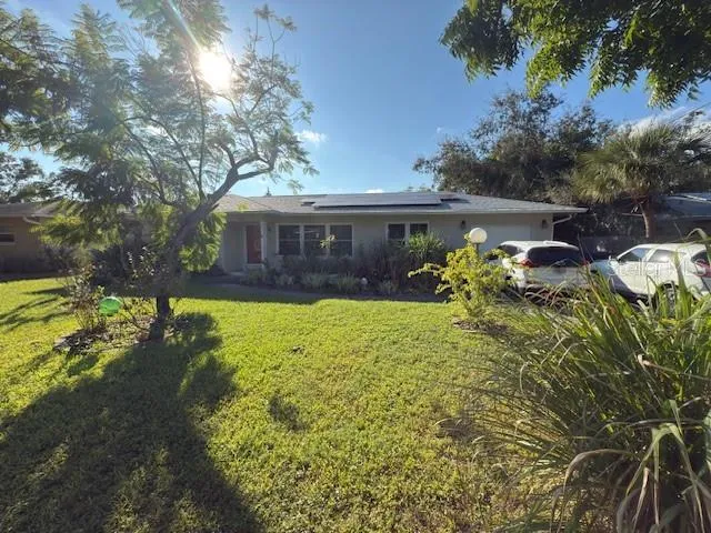 a view of a house with yard and sitting area