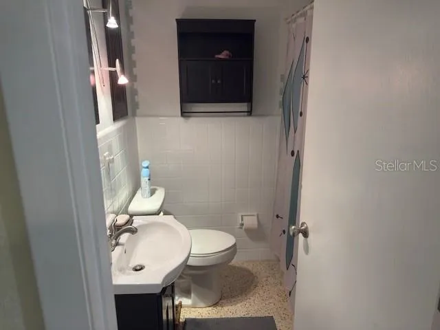 a bathroom with a toilet and a sink