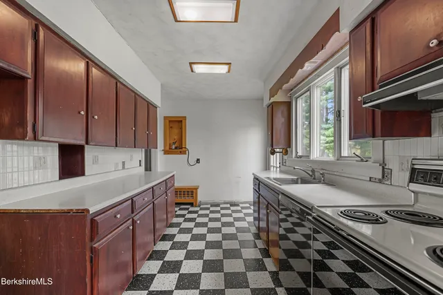 a view of a livingroom with wooden floor and furniture