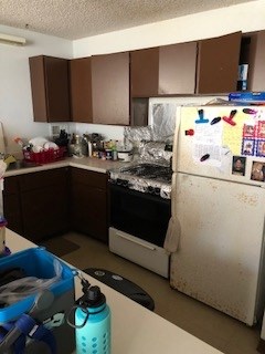 493 Pio Drive, Unit 104 Wailuku, HI 96793 - Photo 2 of 4 a kitchen with granite countertop a sink and a stove