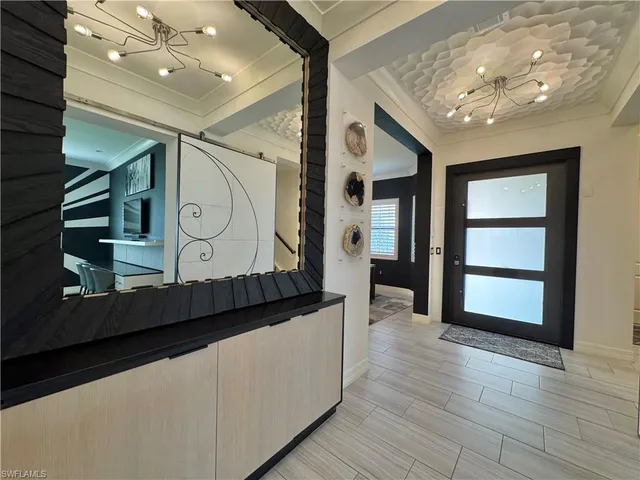 a large kitchen with stainless steel appliances kitchen island granite countertop a refrigerator and a sink