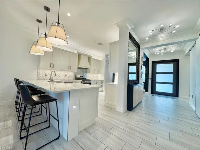 a kitchen with stainless steel appliances granite countertop a stove a sink and a refrigerator