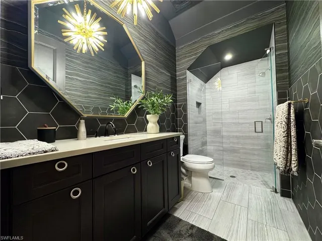 a kitchen with stainless steel appliances a table chairs and chandelier