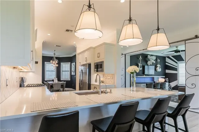 a living room with furniture a floor to ceiling window and a flat screen tv