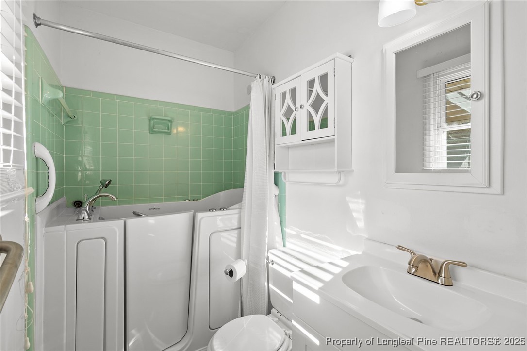 5123 Chesapeake Road Fayetteville, NC 28311 - Photo 20 of 24 a bathroom with a sink toilet and shower