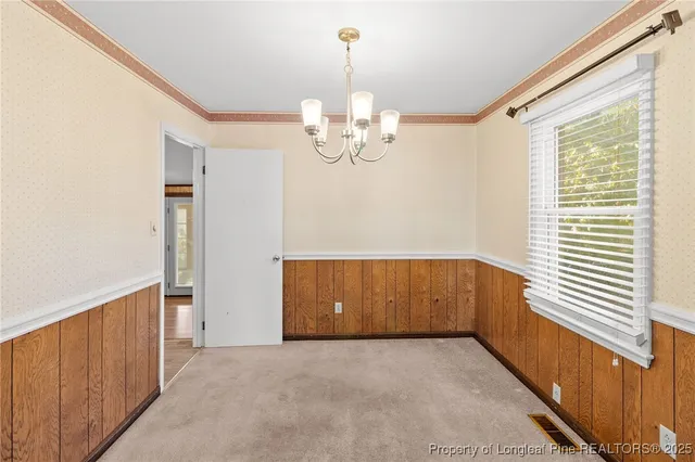 a view of kitchen with window and chandelier