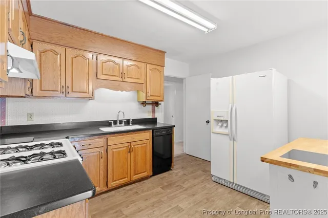 a kitchen with stainless steel appliances granite countertop a stove a refrigerator and a refrigerator
