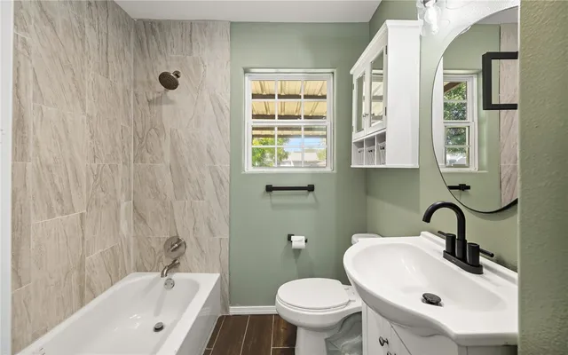 a bathroom with a sink a toilet and a bathtub