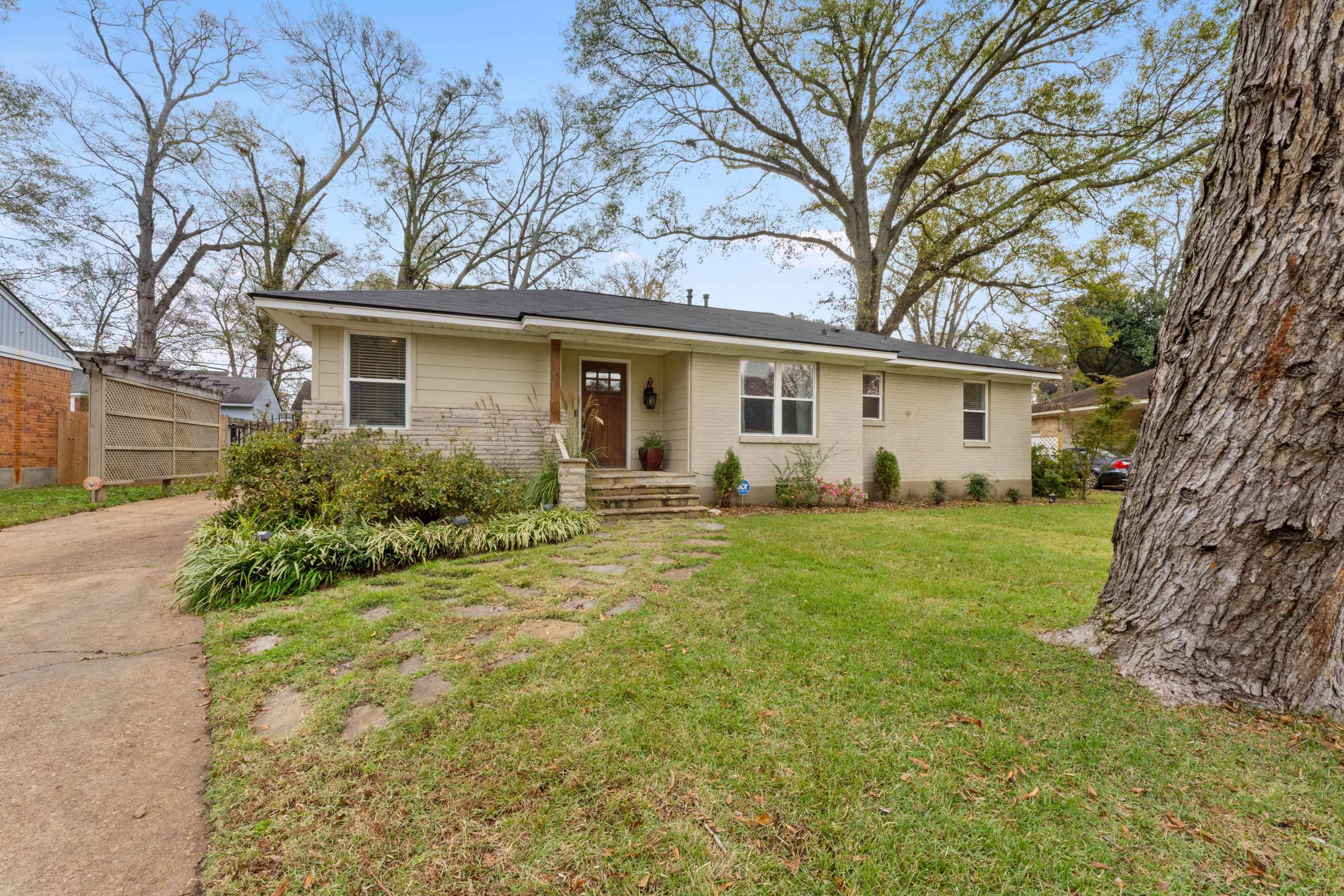 a front view of house with yard and green space