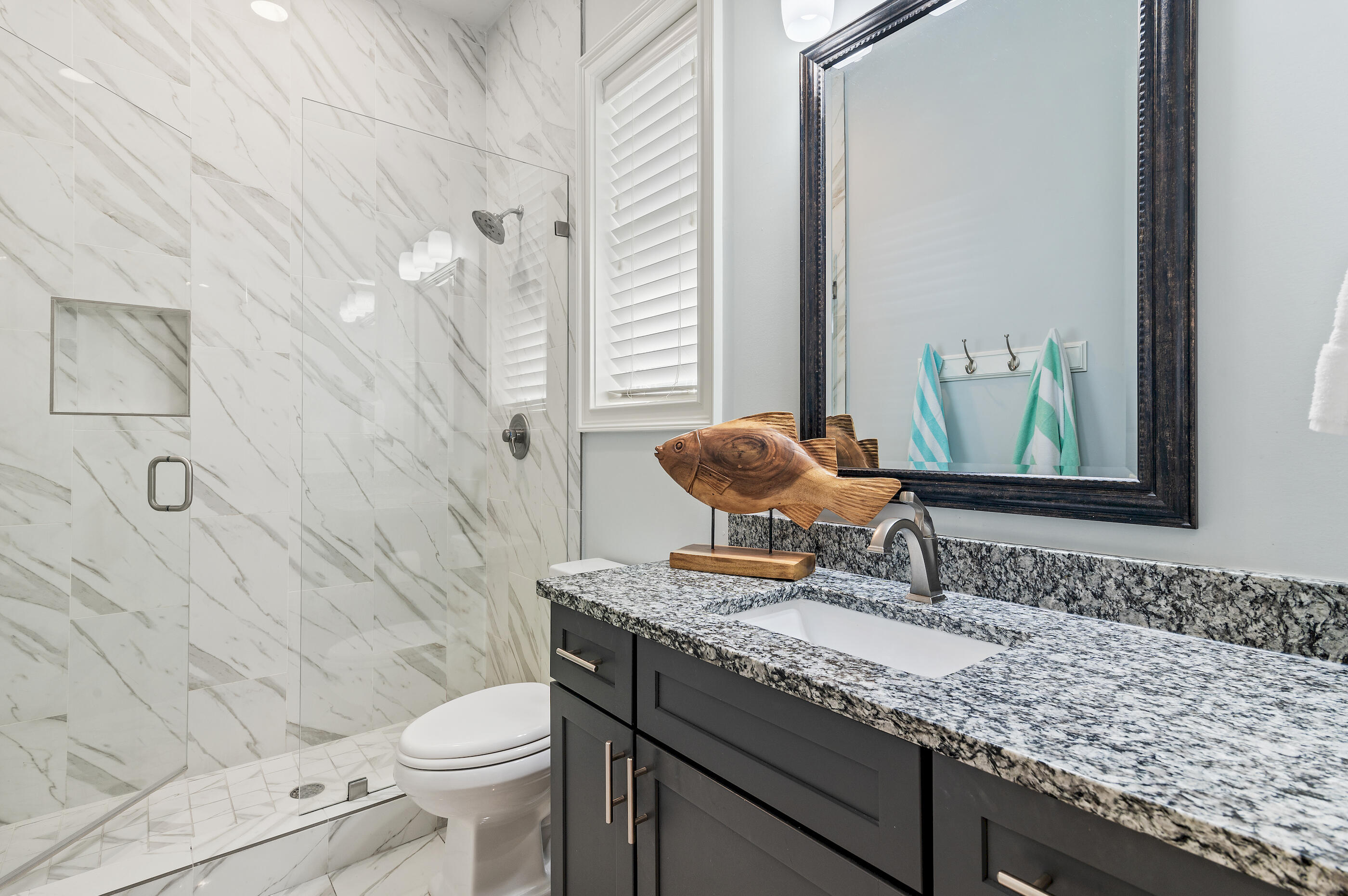 92 Maple Street Santa Rosa Beach, FL 32459 - Photo 33 of 53 a bathroom with a granite countertop toilet a sink and a mirror