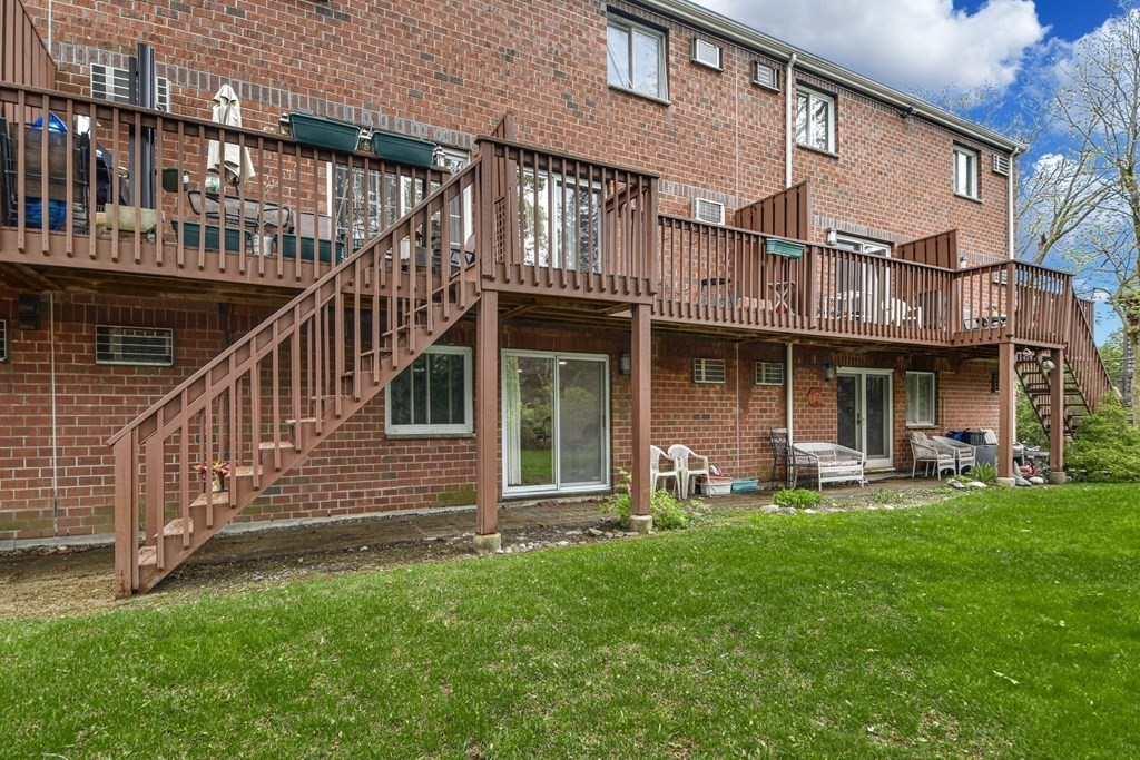 93 B Spring Street, Unit 23 Watertown, MA 02472 - Photo 20 of 21 a view of a house with a yard and sitting area