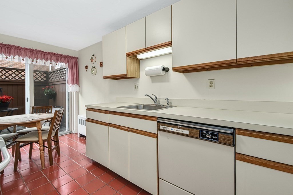 93 B Spring Street, Unit 23 Watertown, MA 02472 - Photo 8 of 21 a kitchen with stainless steel appliances granite countertop a sink and cabinets