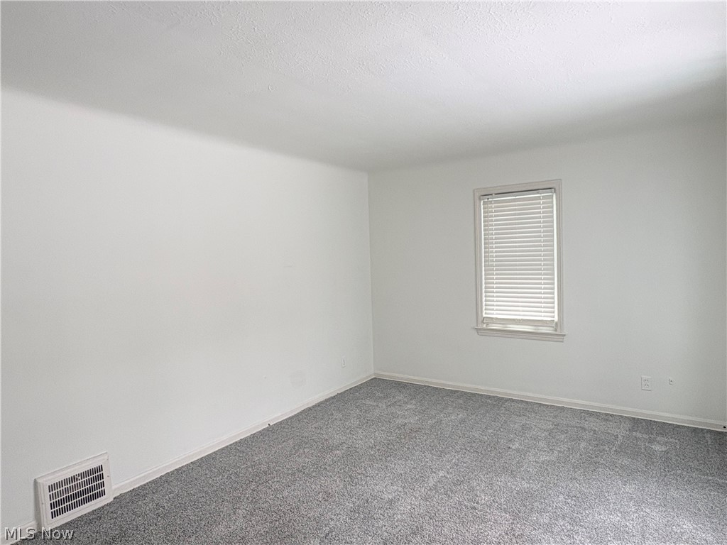 15521 Corkhill Road Maple Heights, OH 44137 - Photo 10 of 33 Spare room with carpet floors and baseboards