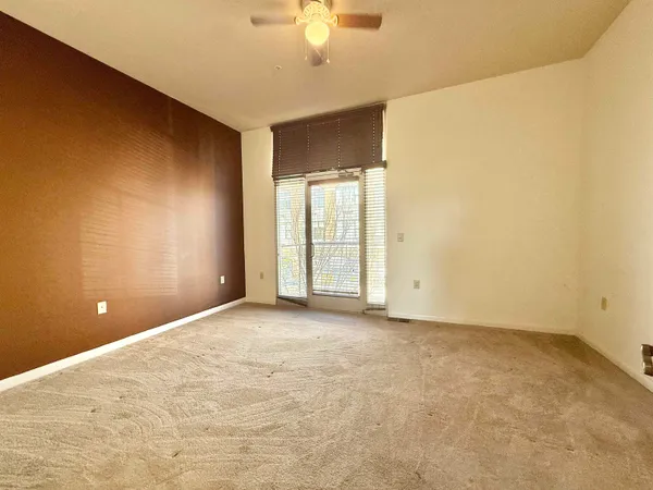 a bathroom with a granite countertop sink a mirror and a shower