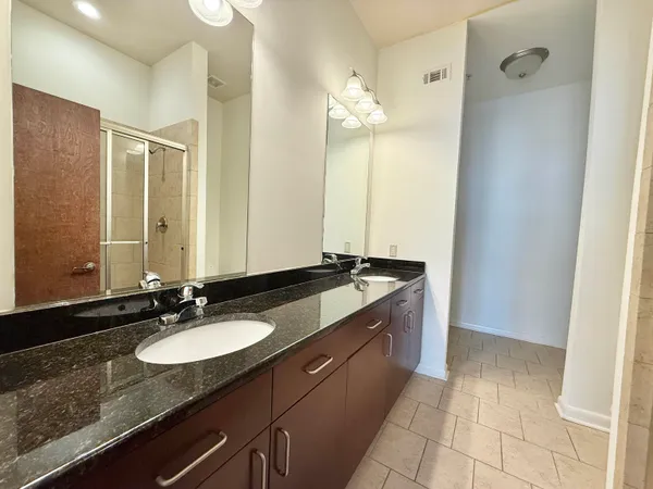 a large bathroom with a tub and shower