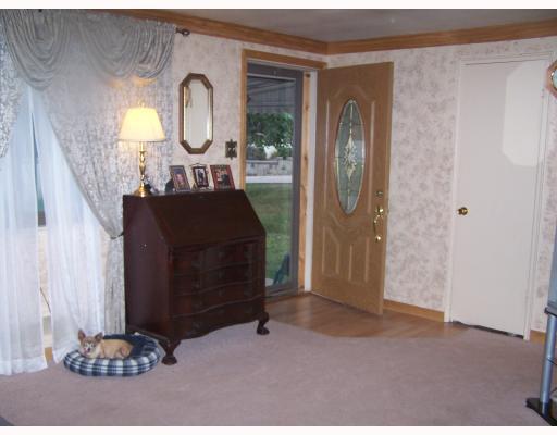 269 Olympic Road Baldwin, PA 15236 - Photo 2 of 12 Living Room. New entrance door and carpeting.Walls are custom painted- ceiling has oak crown molding. Entrance is pergo flooring.