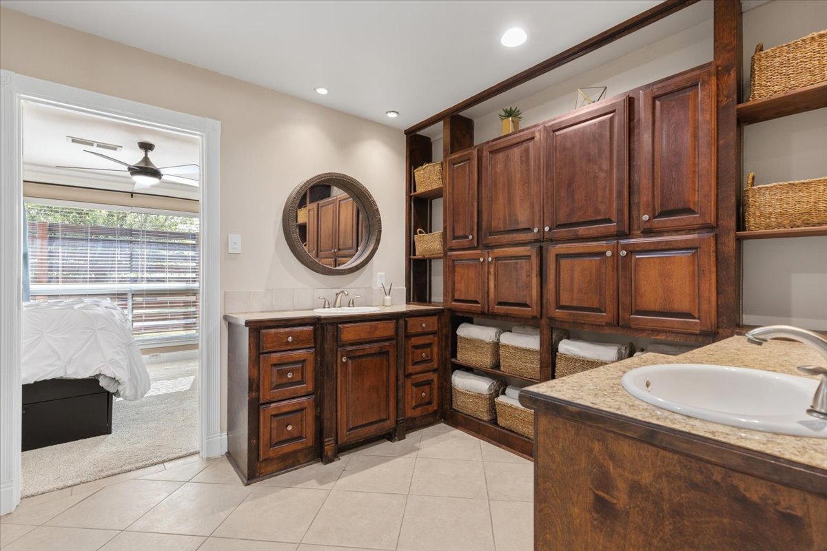 12400 Rusted Nail Cove Austin, TX 78750 - Photo 16 of 31 The primary bathroom features dual vanities and extensive built-in storage.