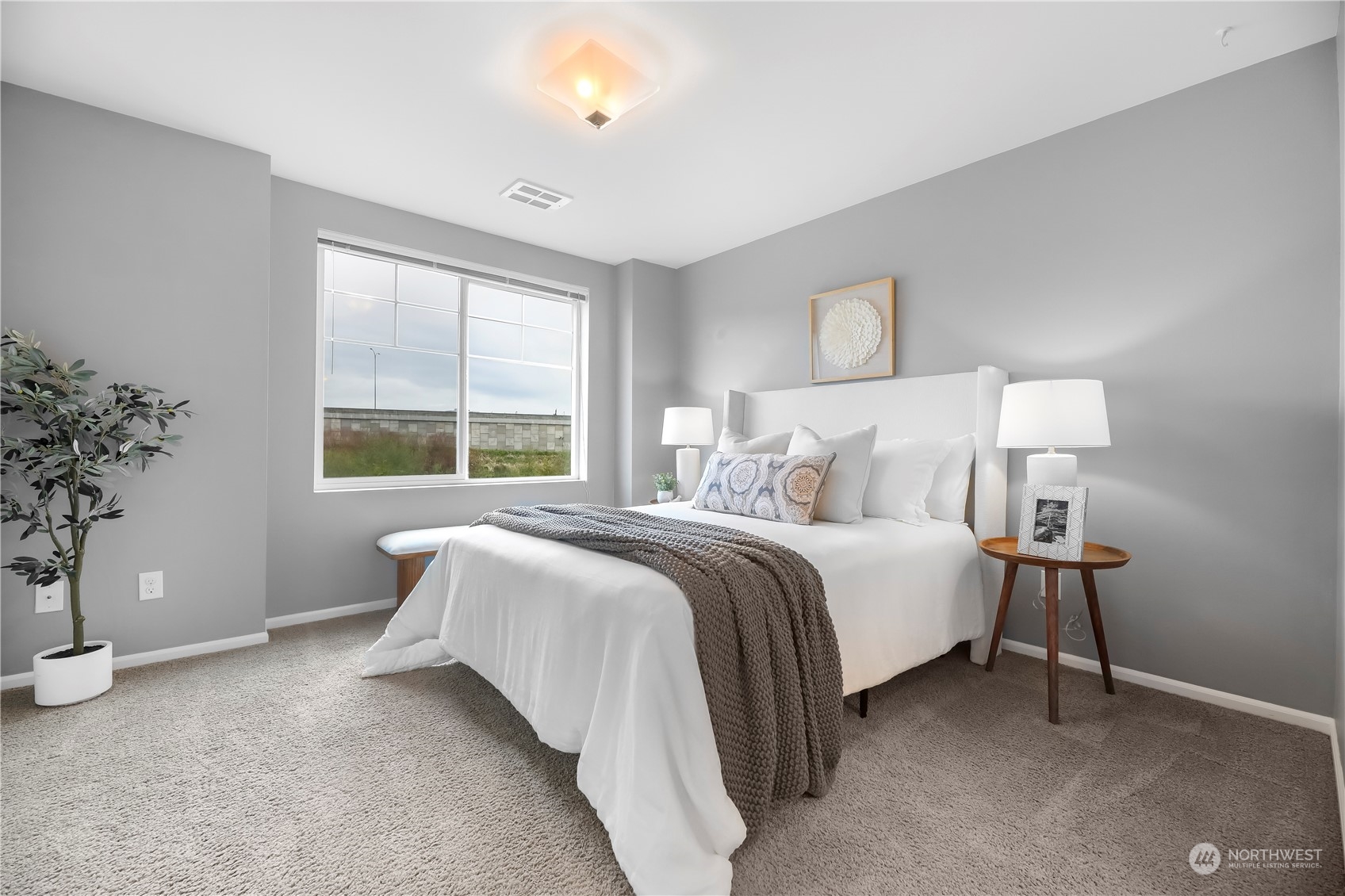 3345 30th Drive Everett, WA 98201 - Photo 21 of 37 a bedroom with a bed and a potted plant