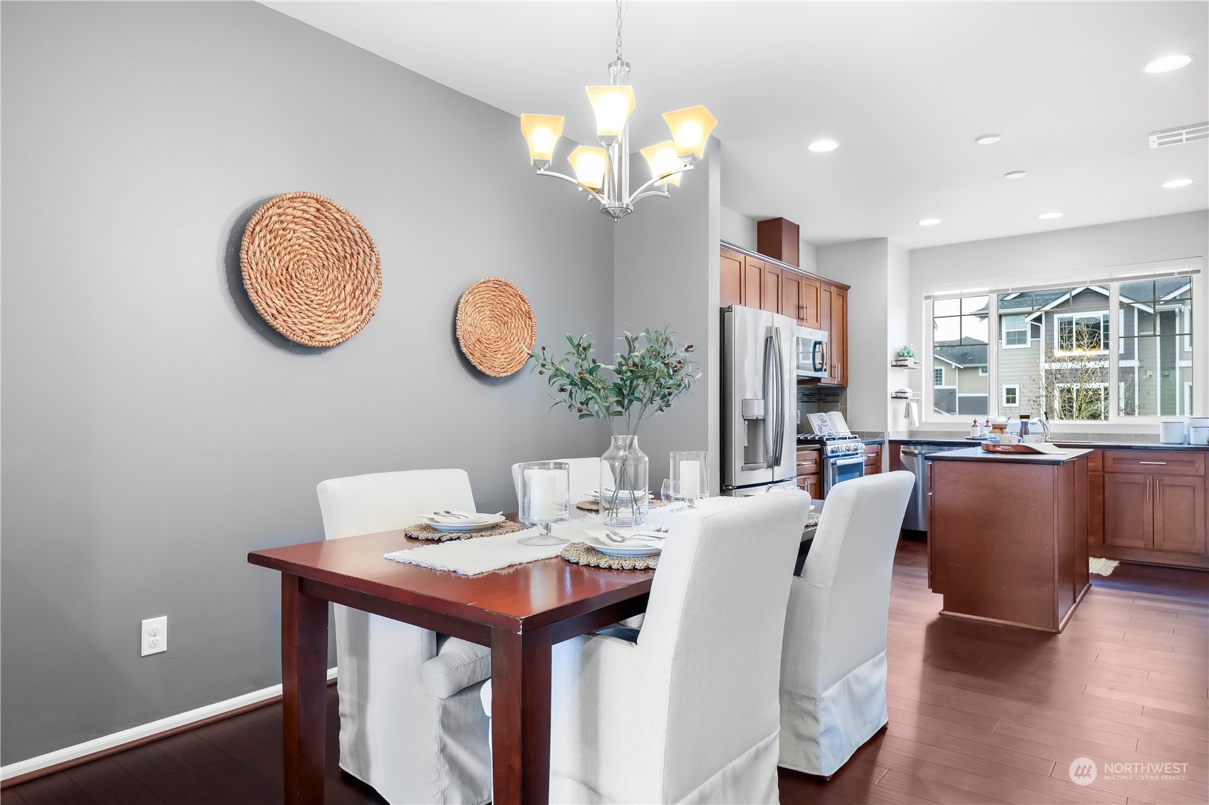 3345 30th Drive Everett, WA 98201 - Photo 9 of 37 a view of a dining room with furniture a chandelier and wooden floor
