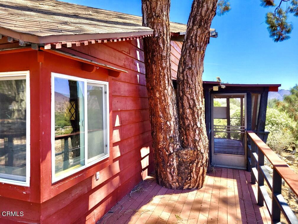 253 Evans Road Wofford Heights, CA 93285 - Photo 4 of 13 a view of a house with a small yard and floor to ceiling window