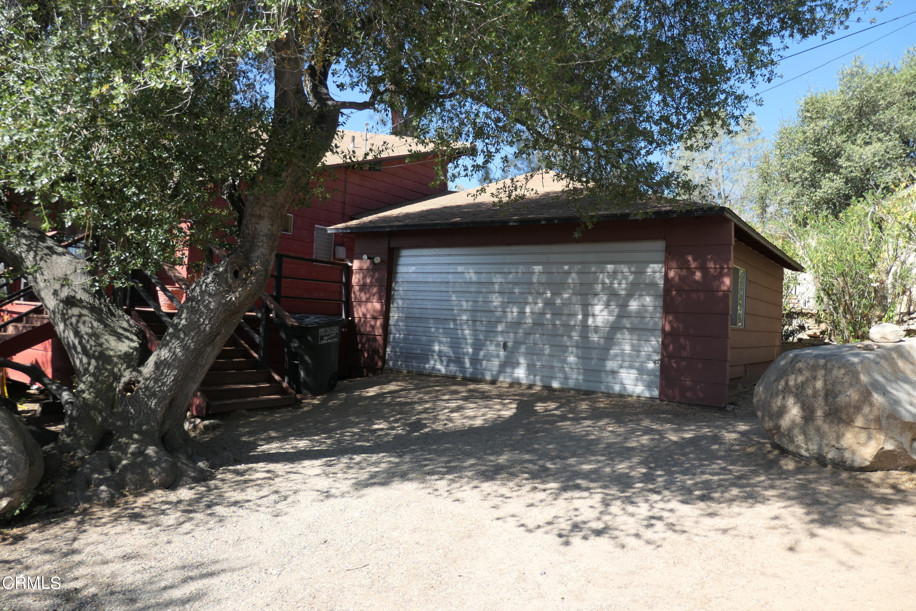 253 Evans Road Wofford Heights, CA 93285 - Photo 7 of 13 a view of a wooden house with a large tree