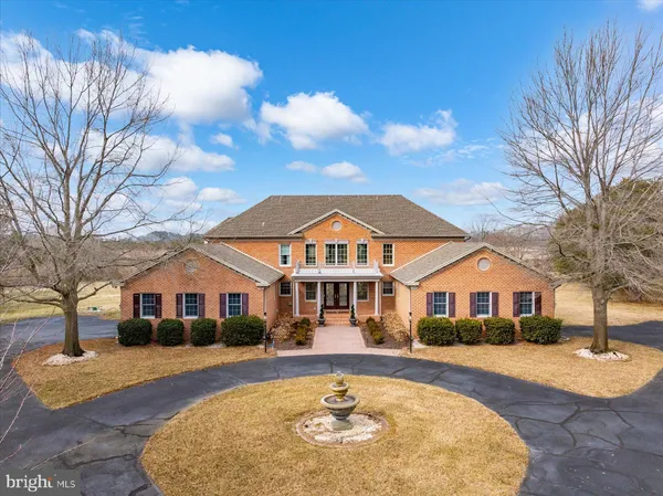 a front view of a house with yard swimming pool and outdoor seating